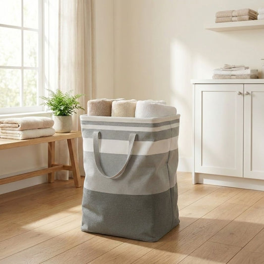 Cesto de ropa sucia de tela a rayas grises y blancas. Bolsa de lavandería grande con asas resistentes para transportar.